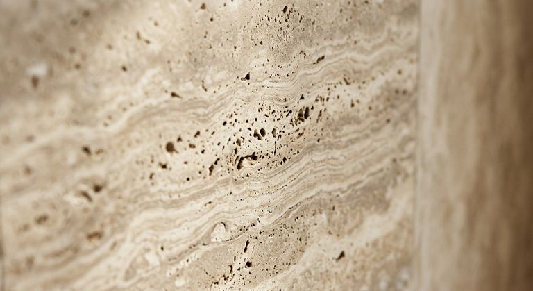 Warm beige travertine surface close-up